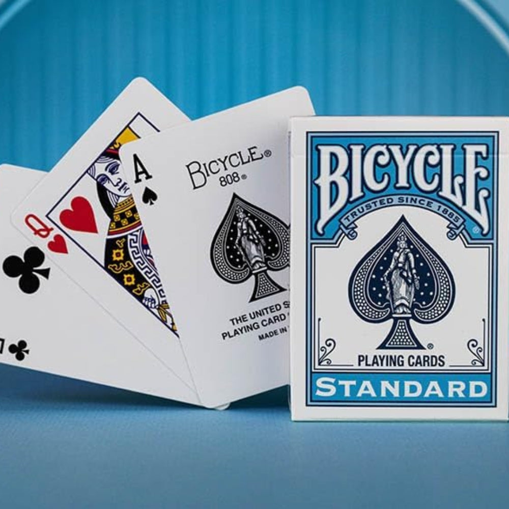 Bicycle playing cards with an Ace of Spades and Queen of Clubs on a blue background